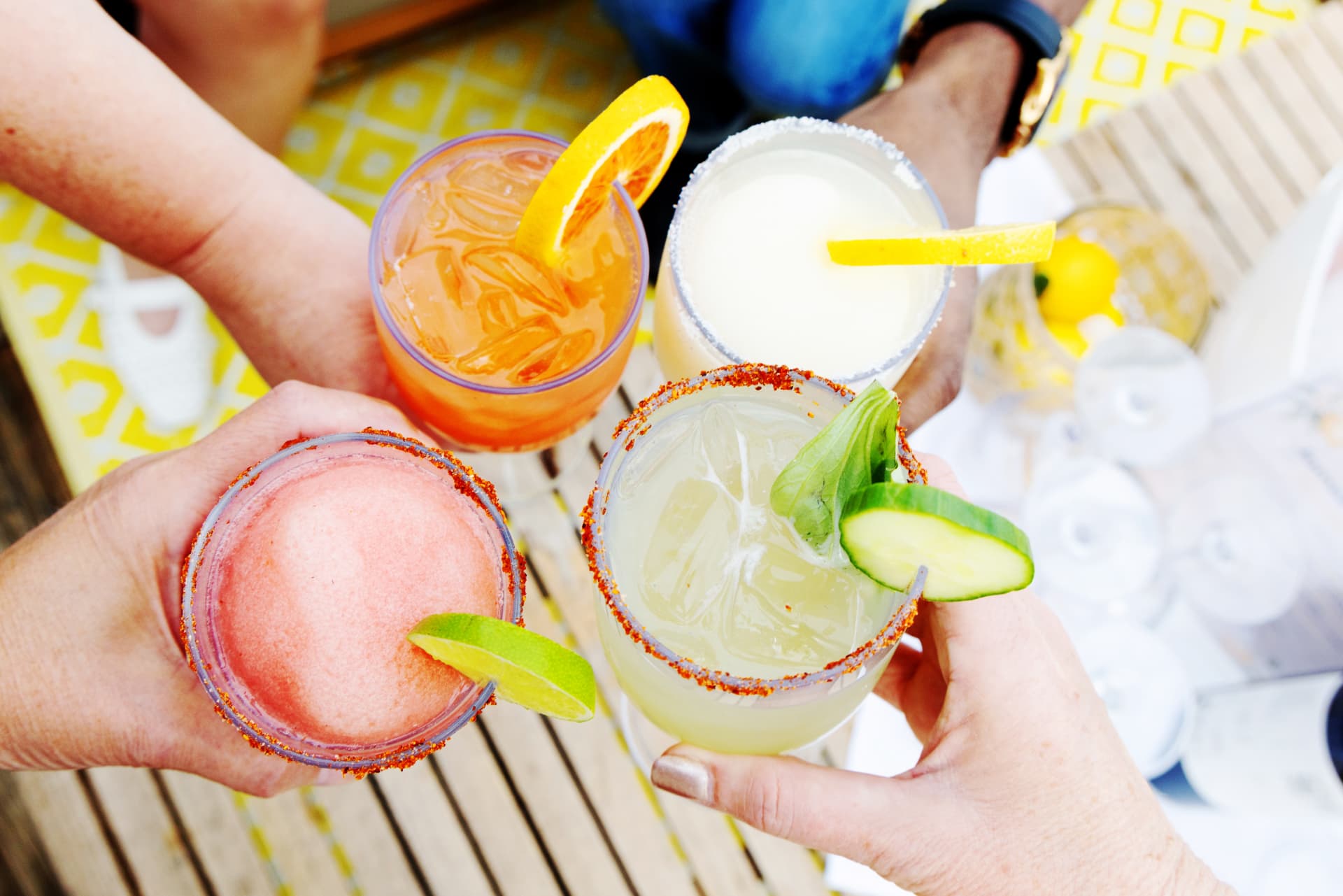 Guests toasting with margaritas and spritzes on the deck
