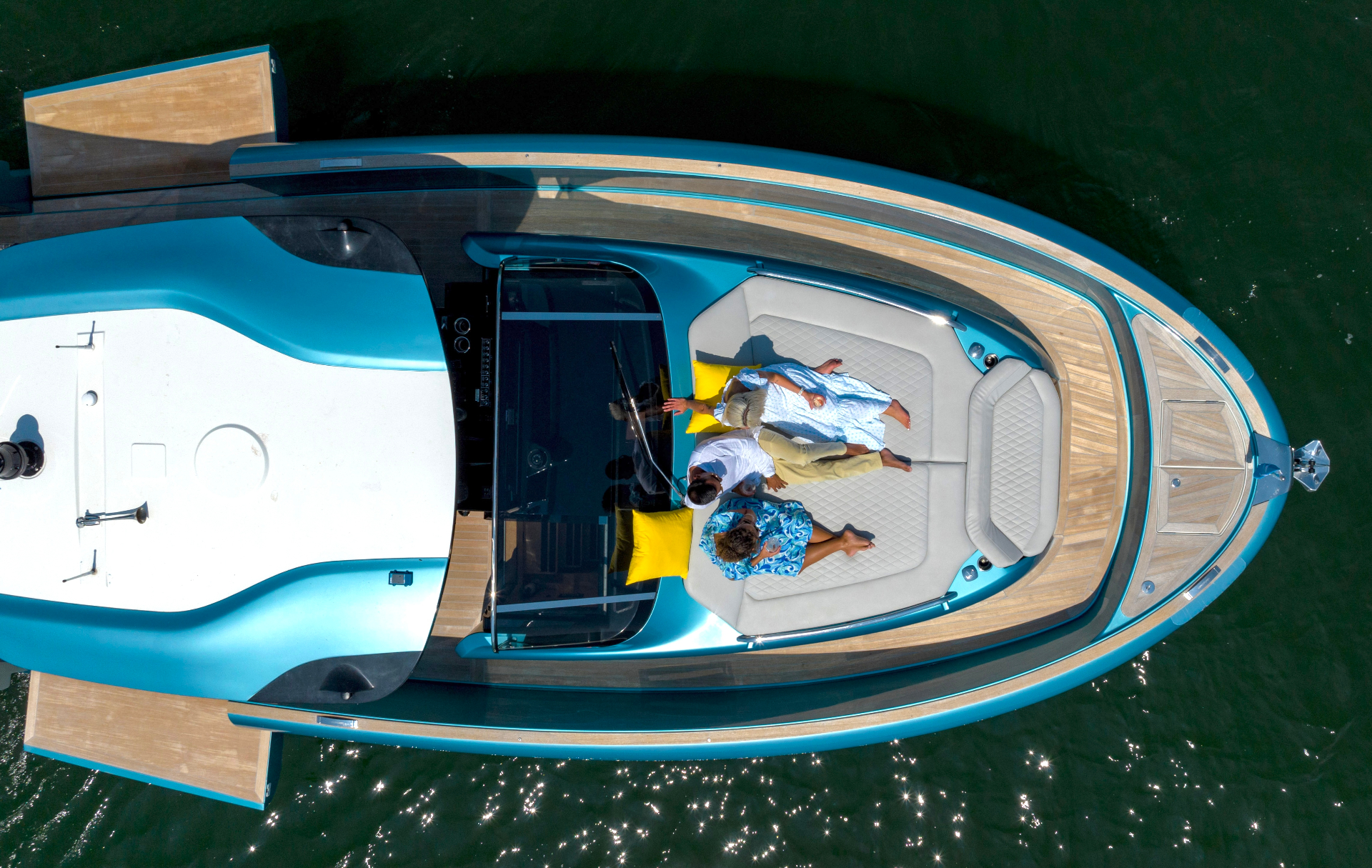 Aerial view of a yacht with guests on the deck