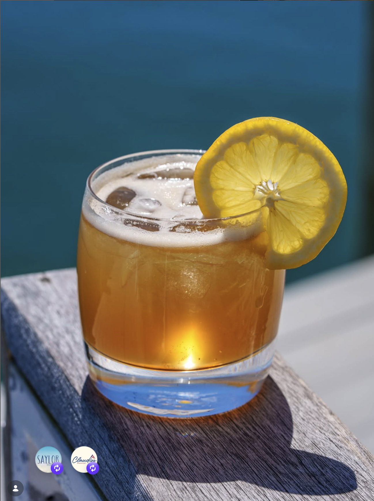 Golden cocktail with lemon on the dock