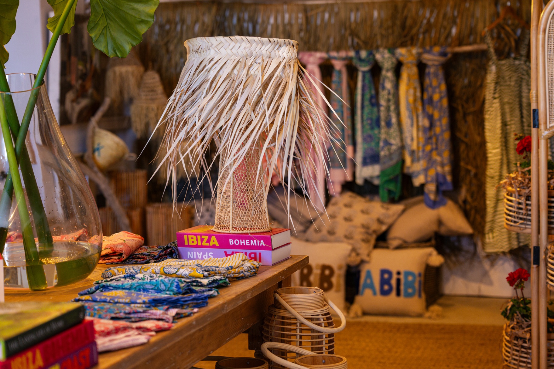 Woven palm-fringe lamp and printed textiles inside Le Shack Beach boutique